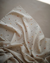 Load image into Gallery viewer, Mushie Organic Muslin Swaddle - Dinosaurs