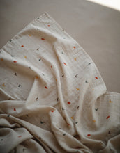 Load image into Gallery viewer, Mushie Organic Muslin Swaddle - Dinosaurs
